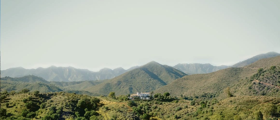 The sierra above Marbella seen from Viluz, ridge behind ridge into the haze.