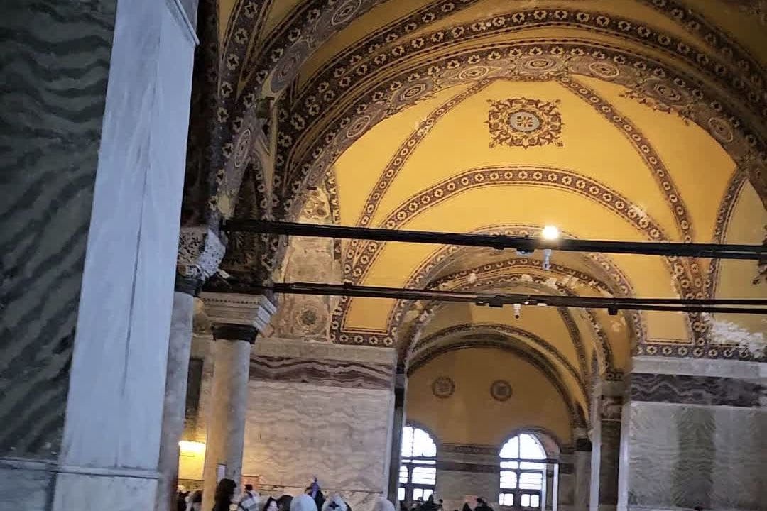 Gold mosaic vaults and marble columns in the upper gallery of Hagia Sophia.